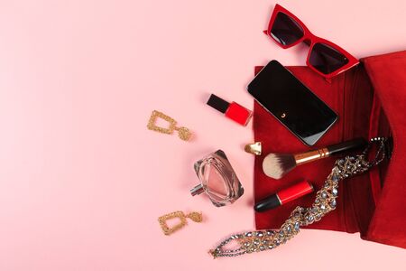Top view of Women bag and lady stuff with copyspace on pink backgroundの写真素材