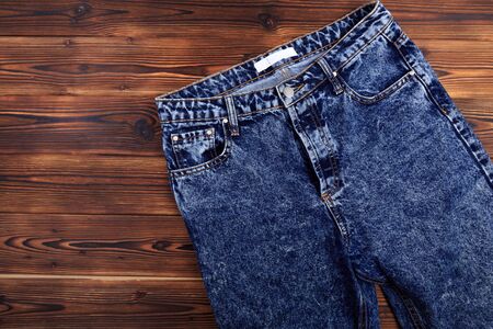 blue denim jeans  on wooden background - Imageの写真素材