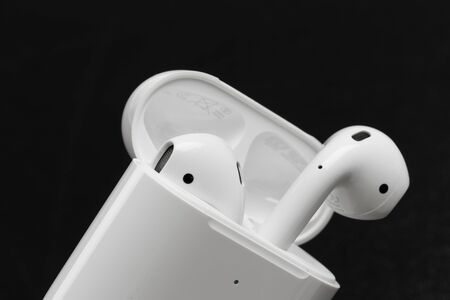 Air Pods. with Wireless Charging Case. New Airpods 2019 on black background.