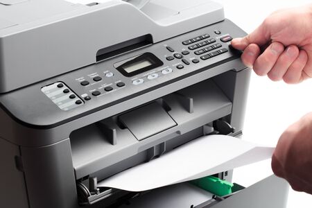 Hand press button on panel of printer. printer scanner laser office copy machine supplies start...