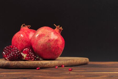 Ripe pomegranate fruit on wooden vintage background.の写真素材