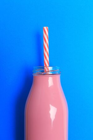 colorful bottle with straw on color background . Minimalism conceptの写真素材