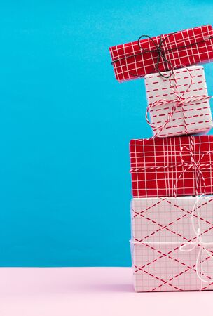 Collection of Christmas present boxes on a light blue backgroundの写真素材