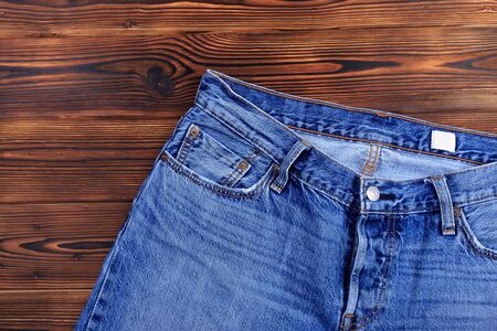blue denim jeans  on wooden background - Image 