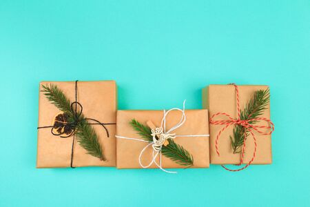 Christmas border. Christmas gifts, fir branches on color background. Flat lay, top view, copy spaceの写真素材