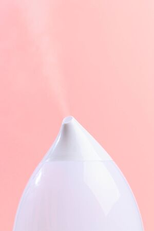 air humidifier on color background .The unique design quickly and effectively eliminates dry air, providing an optimal level of humidity in the room.の写真素材