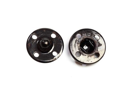 Close up of a group of metal Snap on Buttons on white background