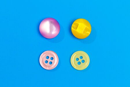 collection of various colored buttons on colored background - Image 