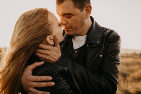 Happy young couple enjoying outdoors during sunset - Imageの写真素材