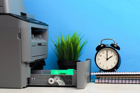 Printer, copier, scanner on color background . Office table