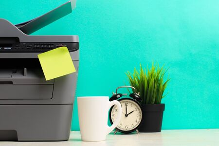 Printer, copier, scanner on color background . Office table