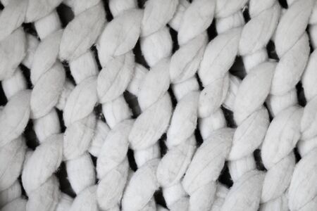background textile white knitted plaid of thick woolen yarn / white knitted plaid