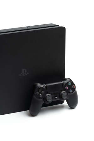 Russia, OKTOBER 24 2019: Sony PlayStation 4 game console and controller, closeup on a white...