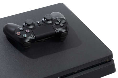 Russia, OKTOBER 24 2019: Sony PlayStation 4 game console and controller, closeup on a white...