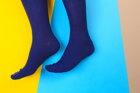 legs in colorful socks on colorful  backgroundの写真素材