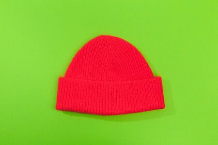 red beanie hat on green  background