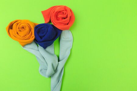 colorful socks on green background flower shapedの写真素材