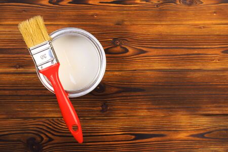 House renovation, paint can on the old wooden background with copy spaceの写真素材