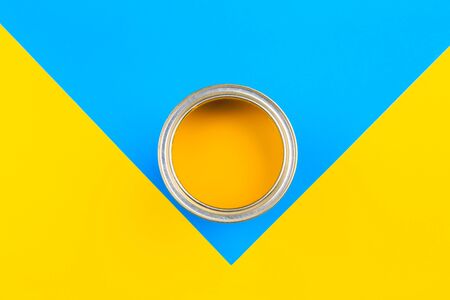 Yellow  Paint Can with Brush Top View On multicolor Background.の写真素材