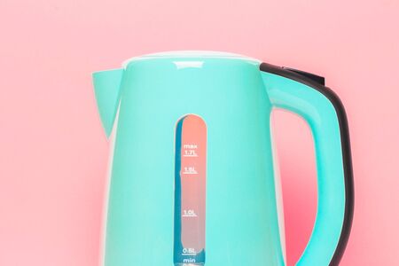 modern green electric kettle on pastel background backgroundの写真素材