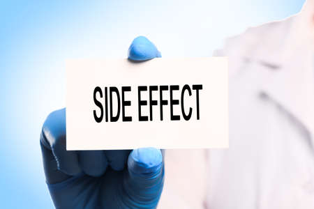 doctor holding a word  complications  on blue background  - Image