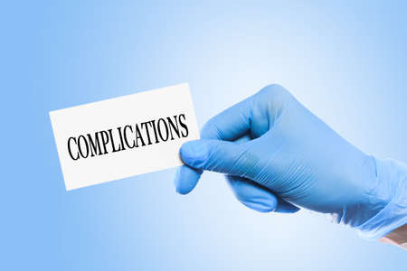 doctor holding a word  Side Effects  on blue background  - Imageの写真素材