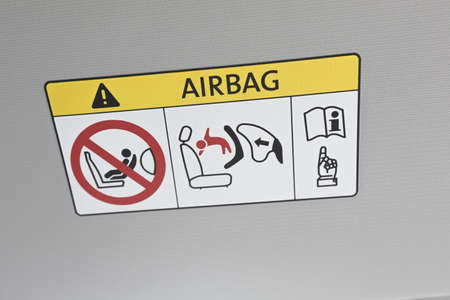 Airbag instruction sign. Forbidden information for using infant car seat on the car dashboard. Caution airbag logo.の写真素材