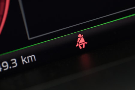 badge of an unfastened seat belt on the electronic panel in the carの写真素材
