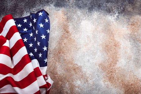 American rolled flag on grunge backgroundの写真素材