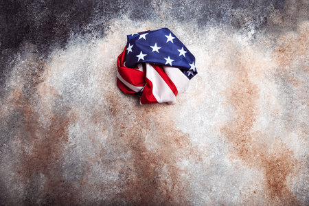 American rolled flag on grunge backgroundの写真素材