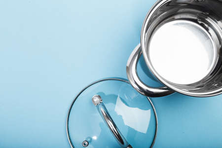 steel pan with a transparent lid on blue background - Imageの写真素材