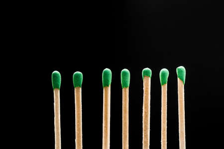 matches standing in a row on black backgroundの写真素材