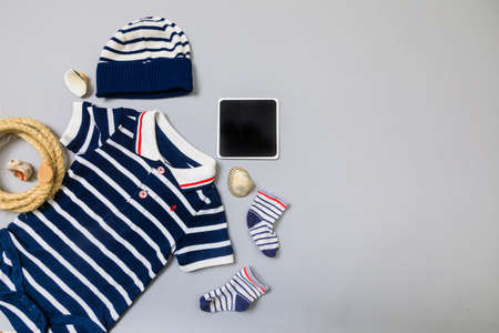Baby concept. Baby cloth and goods on grey  background. Place for text. View from above. Flat Lay