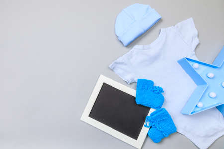 Baby concept. Baby cloth and goods on grey  background. Place for text. View from above. Flat Lay