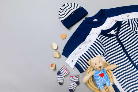 Baby concept. Baby cloth and goods on grey  background. Place for text. View from above. Flat Lay