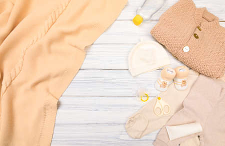 baby boy clothes and hygiene items on a white wooden background. View from aboveの写真素材