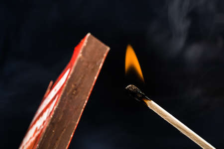 burning match  and box  on black backgroundの写真素材