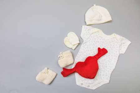 Baby concept. Baby cloth and goods on grey  background. Place for text. View from above. Flat Lay