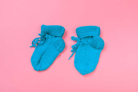 knitted baby booties on pastel pink background - Imageの写真素材