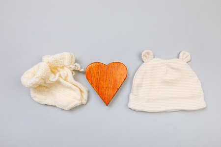 Baby concept. knitted things for the baby handmade on grey  background. Place for text. View from...