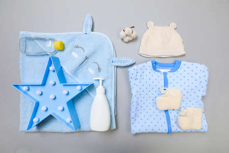 Baby concept. Baby cloth and goods on grey  background. Place for text. View from above. Flat Lay