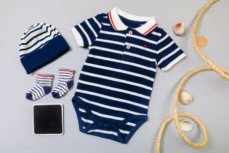 Baby concept. Baby cloth and goods on grey  background. Place for text. View from above. Flat Lay