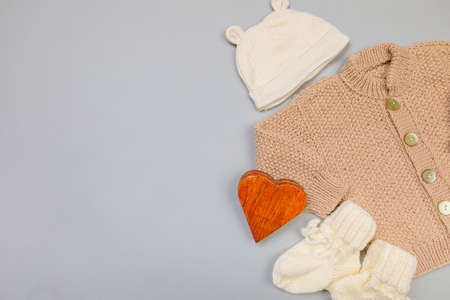 Baby concept. knitted things for the baby handmade on grey  background. Place for text. View from above. Flat Layの写真素材