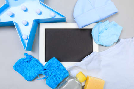 Baby concept. Baby cloth and goods on grey  background. Place for text. View from above. Flat Lay
