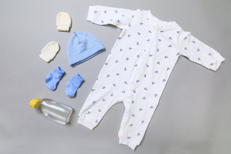 Baby concept. Baby cloth and goods on grey  background. Place for text. View from above. Flat Lay
