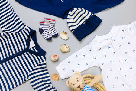 Baby concept. Baby cloth and goods on grey  background. Place for text. View from above. Flat Lay