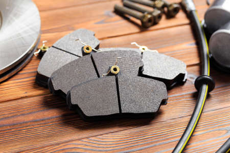 brake parts on wooden background  brake pads, disc, brake hose, guides, cylindersの写真素材