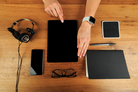 Female hands working on wooden work place with modern gadgets  top view - Imageの写真素材
