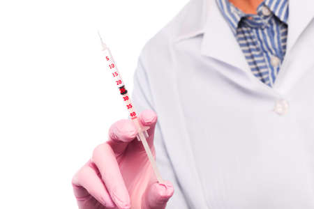 Doctor hand in sterile gloves holding syringe  isolated on white backgroundの写真素材