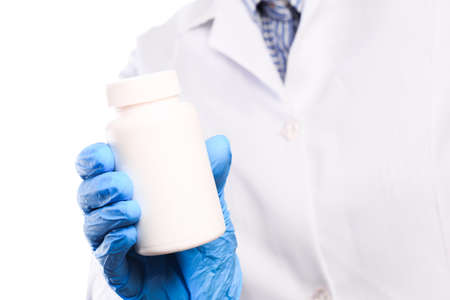 Doctor hand in sterile gloves holding jar with pills isolated on white background